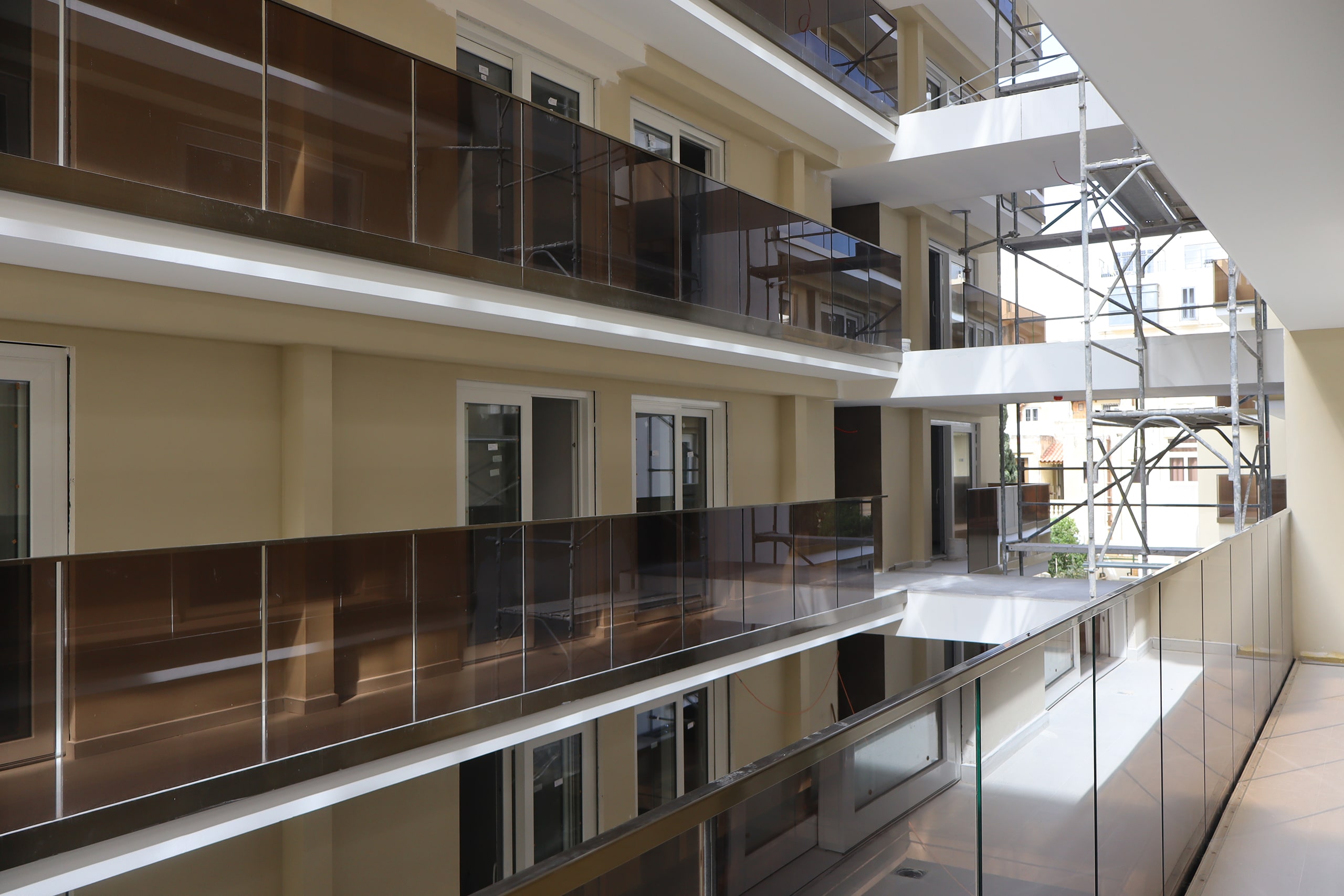 Apartment balconies with glass balustrades during construction by ST Projects